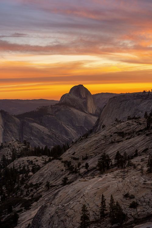 Free Breathtaking view of Half Dome in Yosemite Valley at sunset, showcasing vibrant skies and rough terrain. Stock Photo