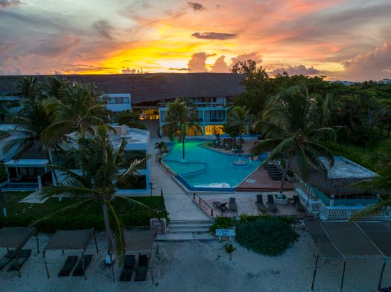 Beachfront resort and pool at sunset, by Stephen Leonardi on Pexels