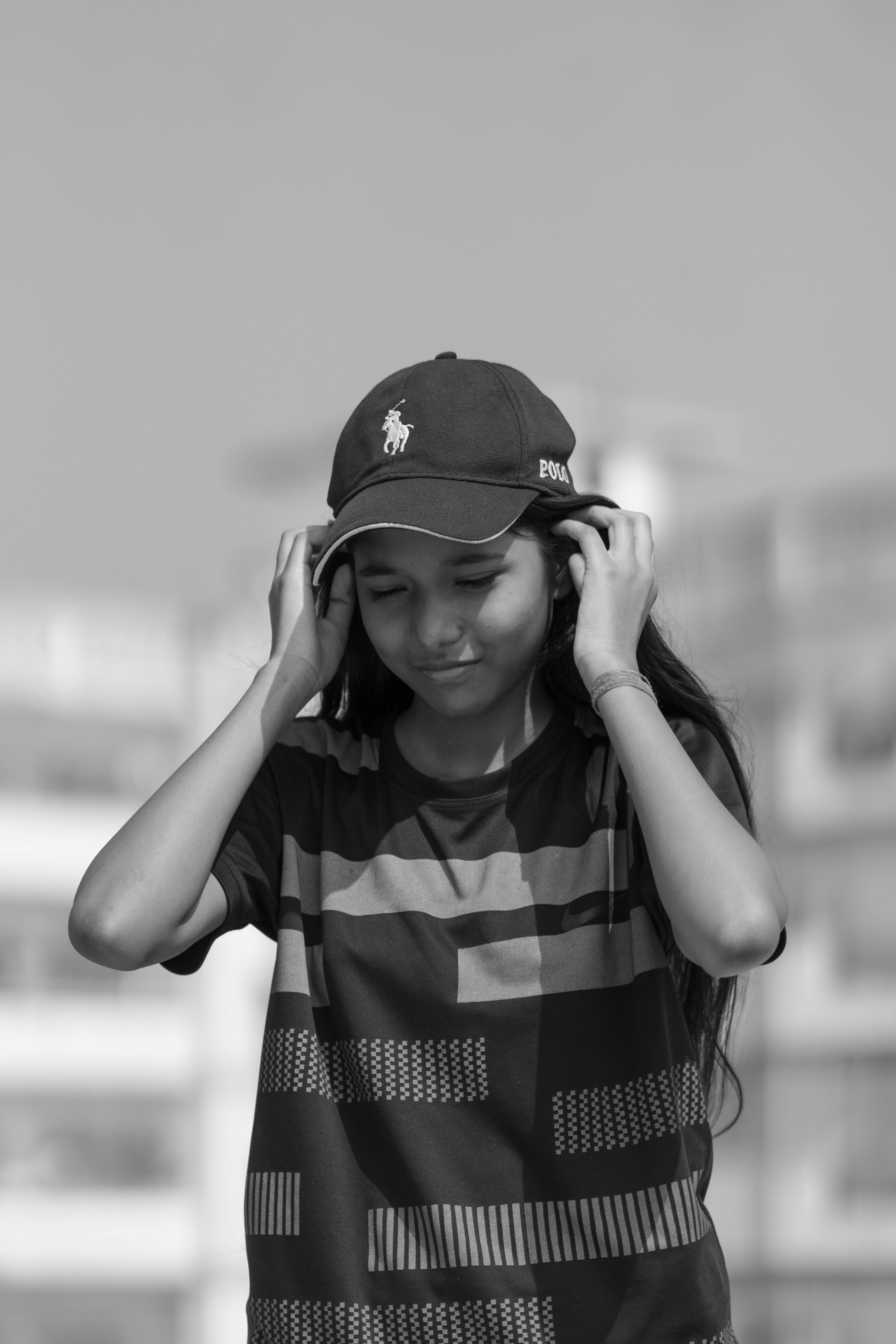 a girl in a baseball cap and shirt