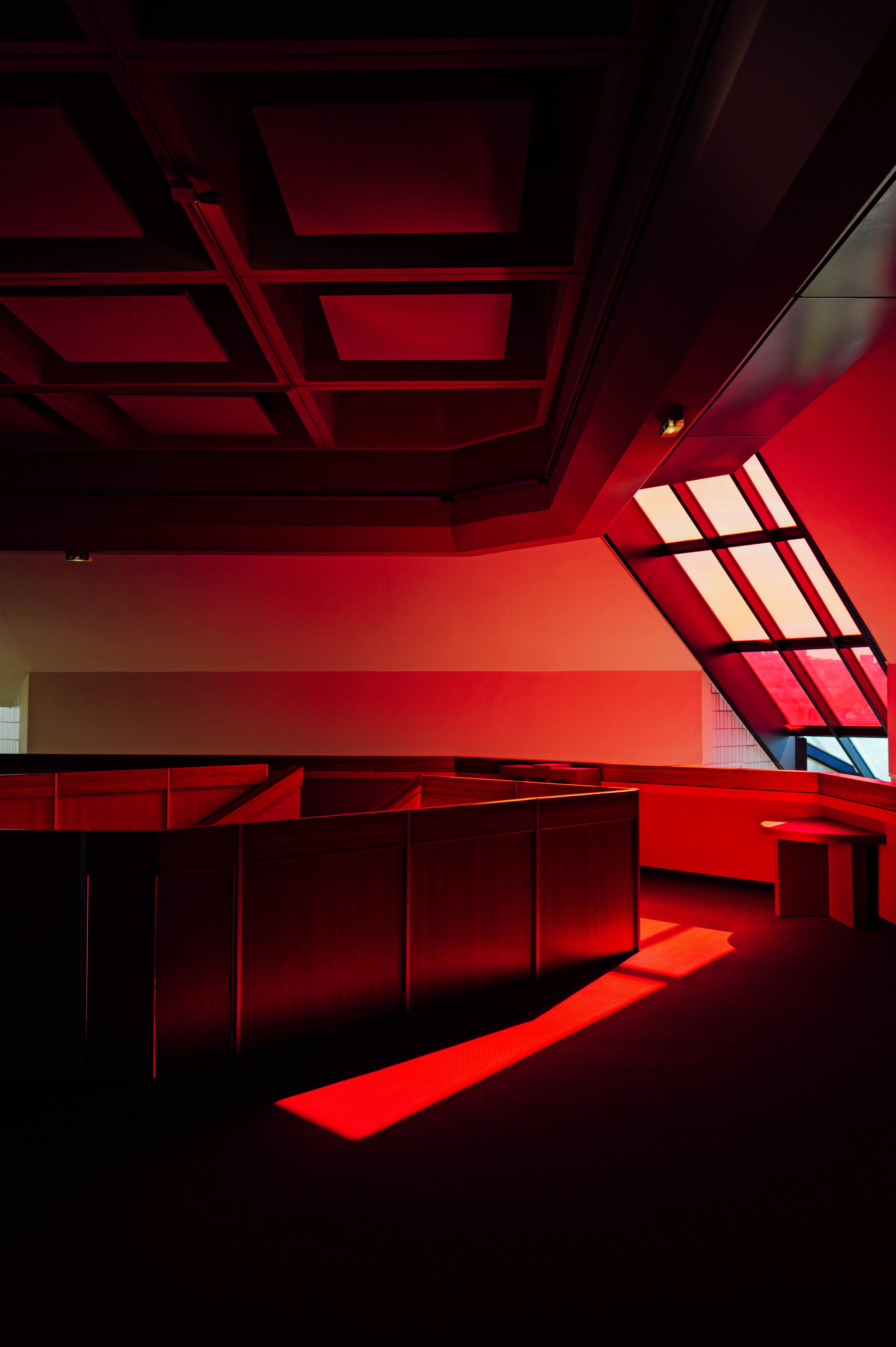 A red light shines in the corner of a room · Free Stock Photo