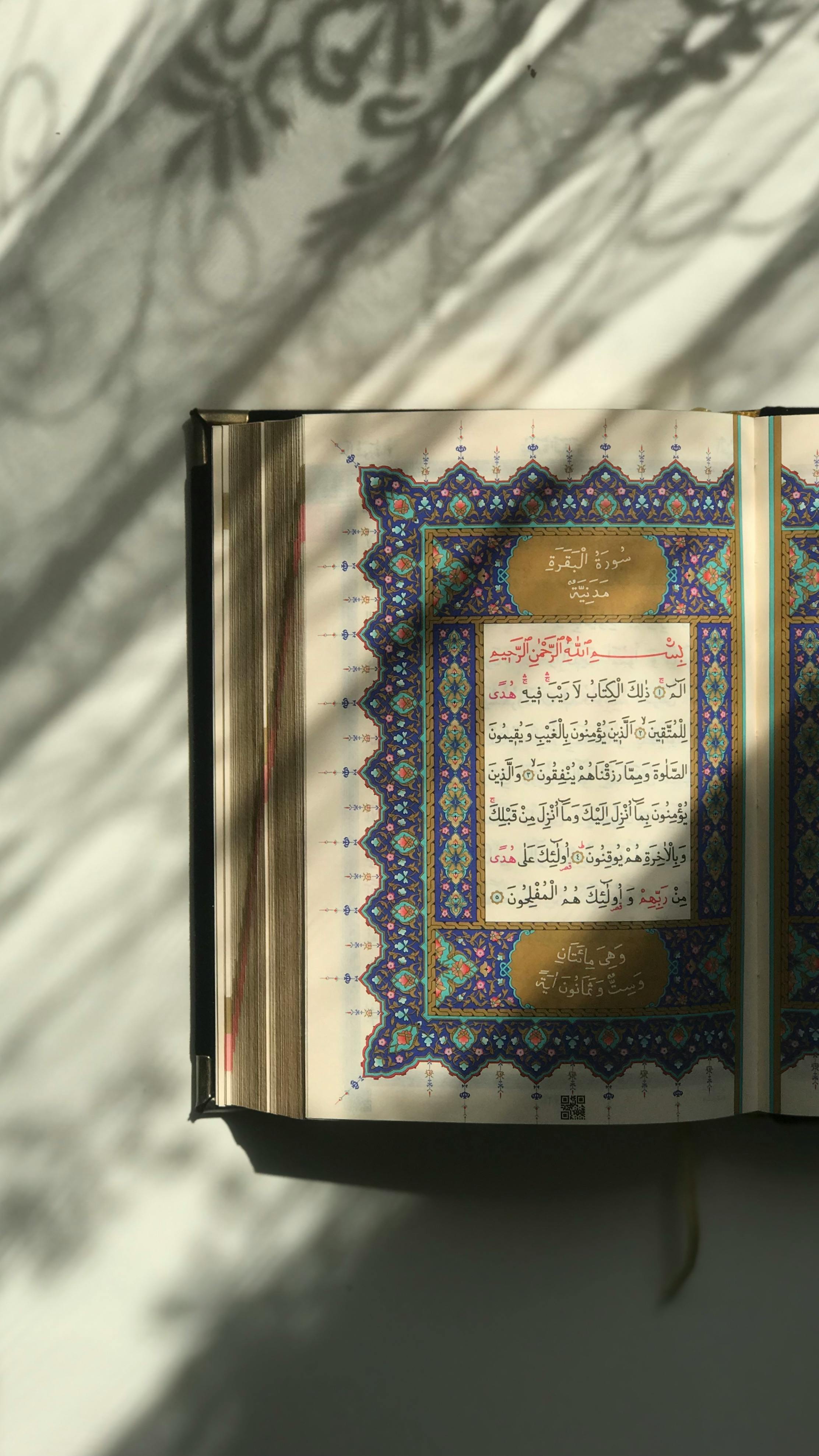 An open Quran basking in sunlight, casting intricate shadows.