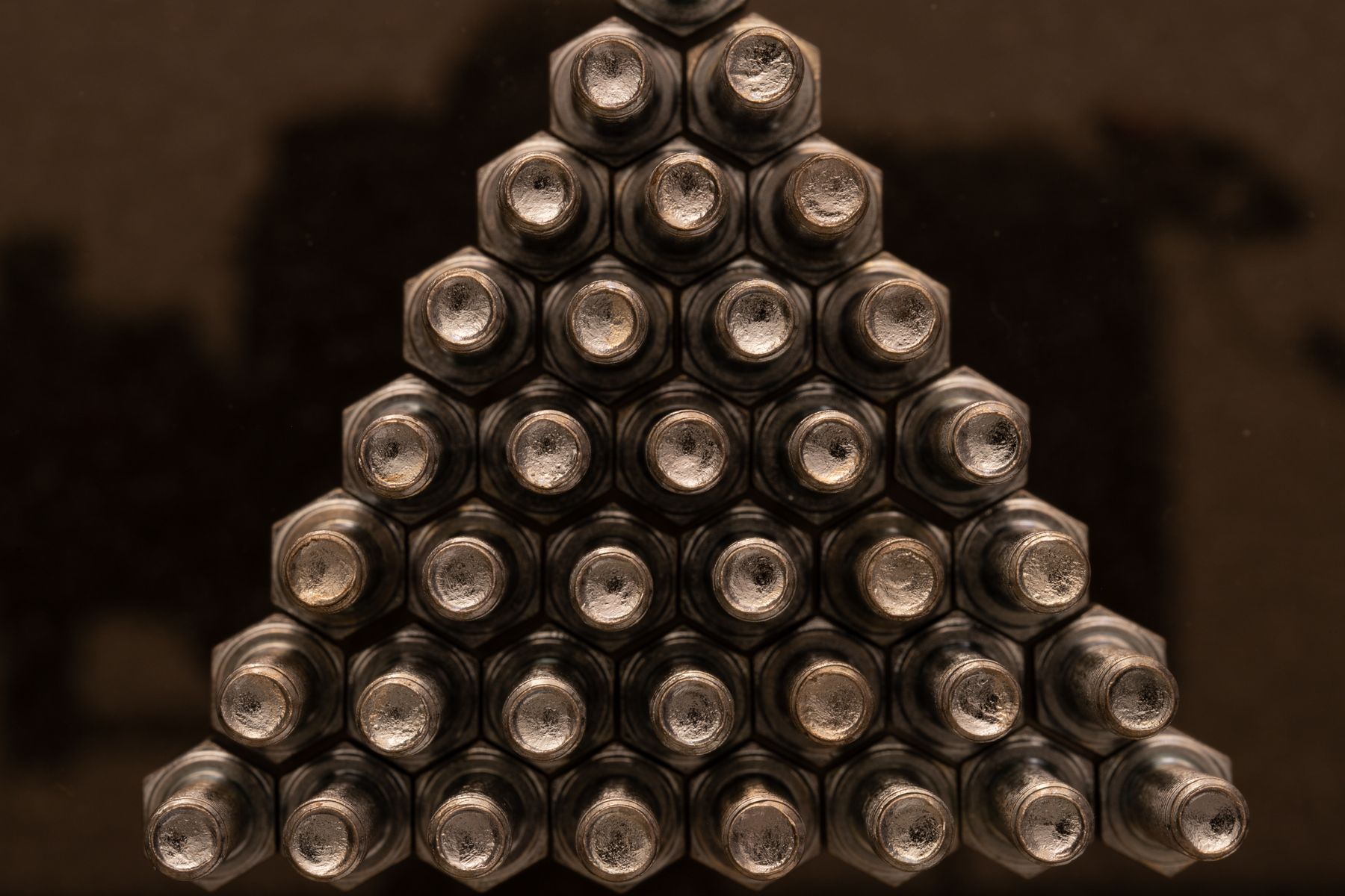 Industrial nuts arranged on a dark surface
