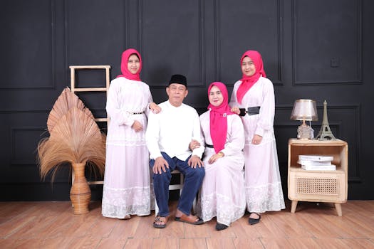 Four family members posing in matching traditional outfits indoors.