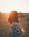 Person looking over shoulder at sunset
