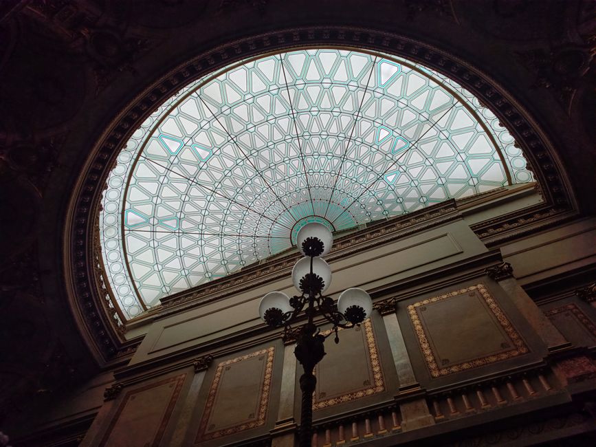 Beautiful dome ceiling featuring intricate glasswork and elegant architecture indoors.