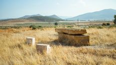 Stone ruins set against a rural Jendouba landscape, evoking Roman history.