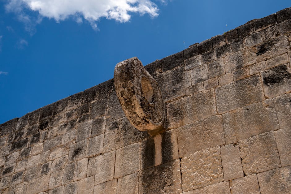 mayan ruins less crowded chichen itza alternatives - Close-up of a Mayan ball game ring on a stone wall in Chichén Itzá, under a clear blue sky.