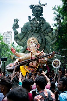 Crowd celebrates Ganesh Chaturthi with statues and festivities in Mumbai, India.