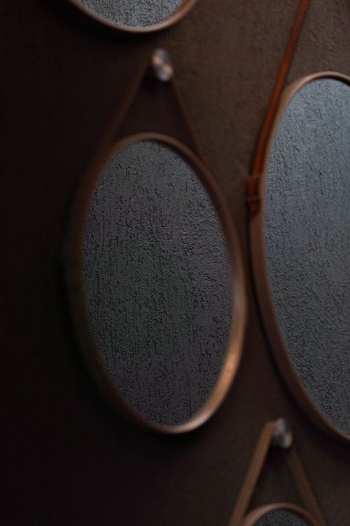 Free A stylish arrangement of reflective metallic mirrors against a textured wall, exuding modern elegance. Stock Photo