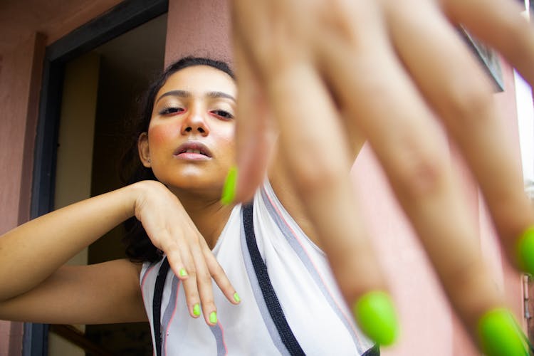 Woman With Green Painted Nails Posing