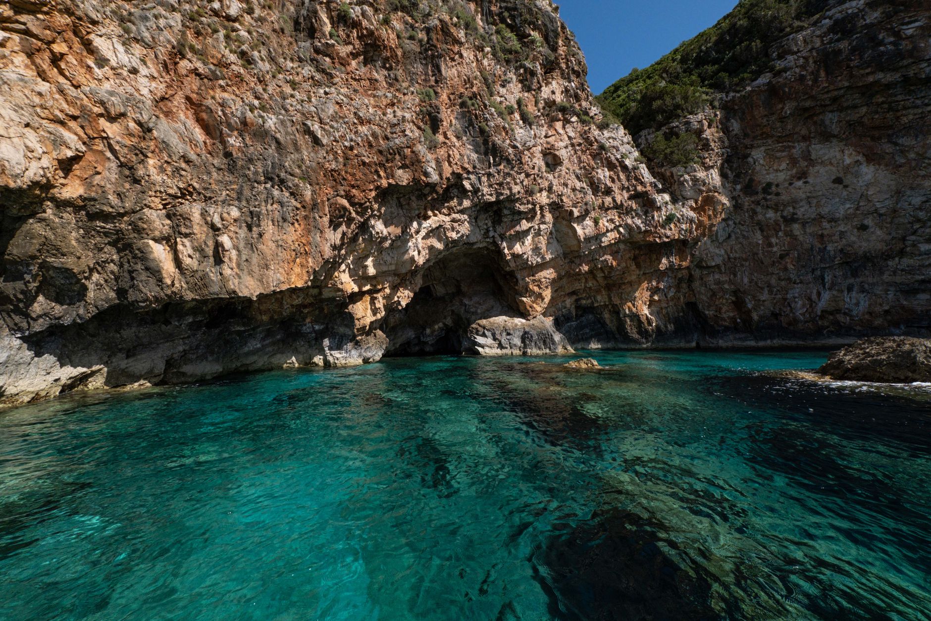 Explore a stunning coastal scene with vibrant turquoise water and rugged cliffs, perfect for travel inspiration.