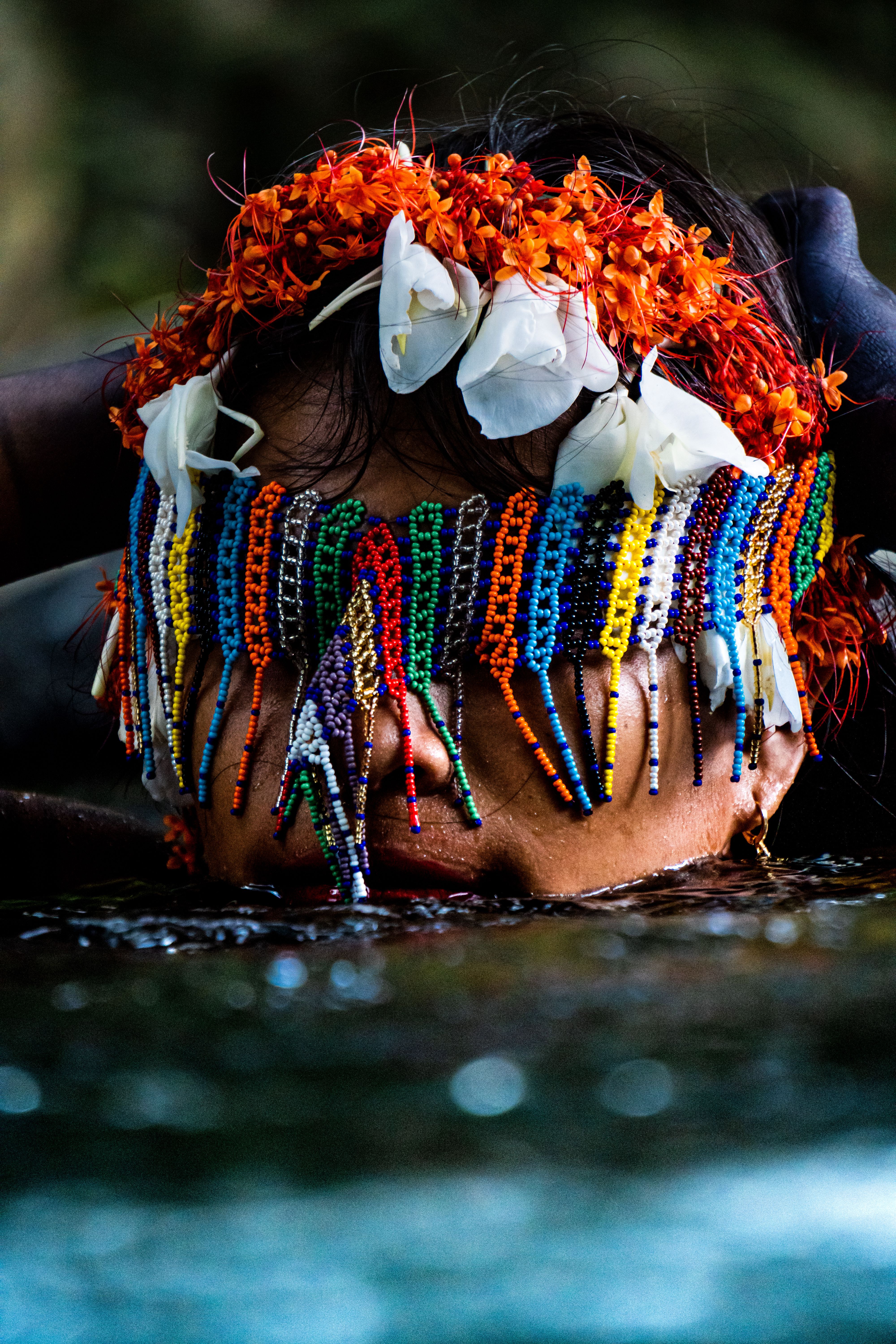 A vibrant portrait of a person wearing a beaded headdress in Nabuga, Colombia.
