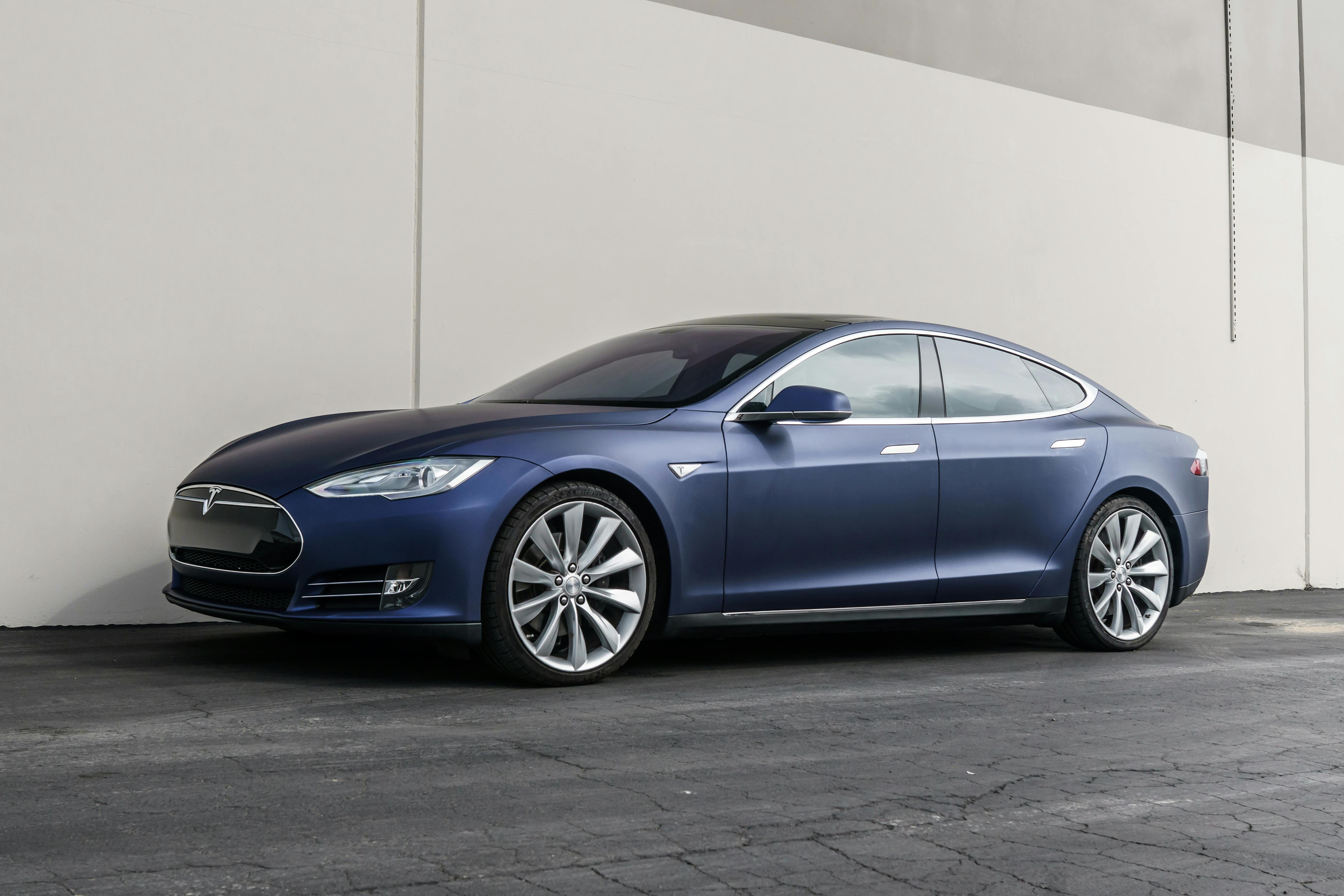 Elegant Tesla Model S parked outdoors against a modern backdrop, showcasing luxury and innovation.