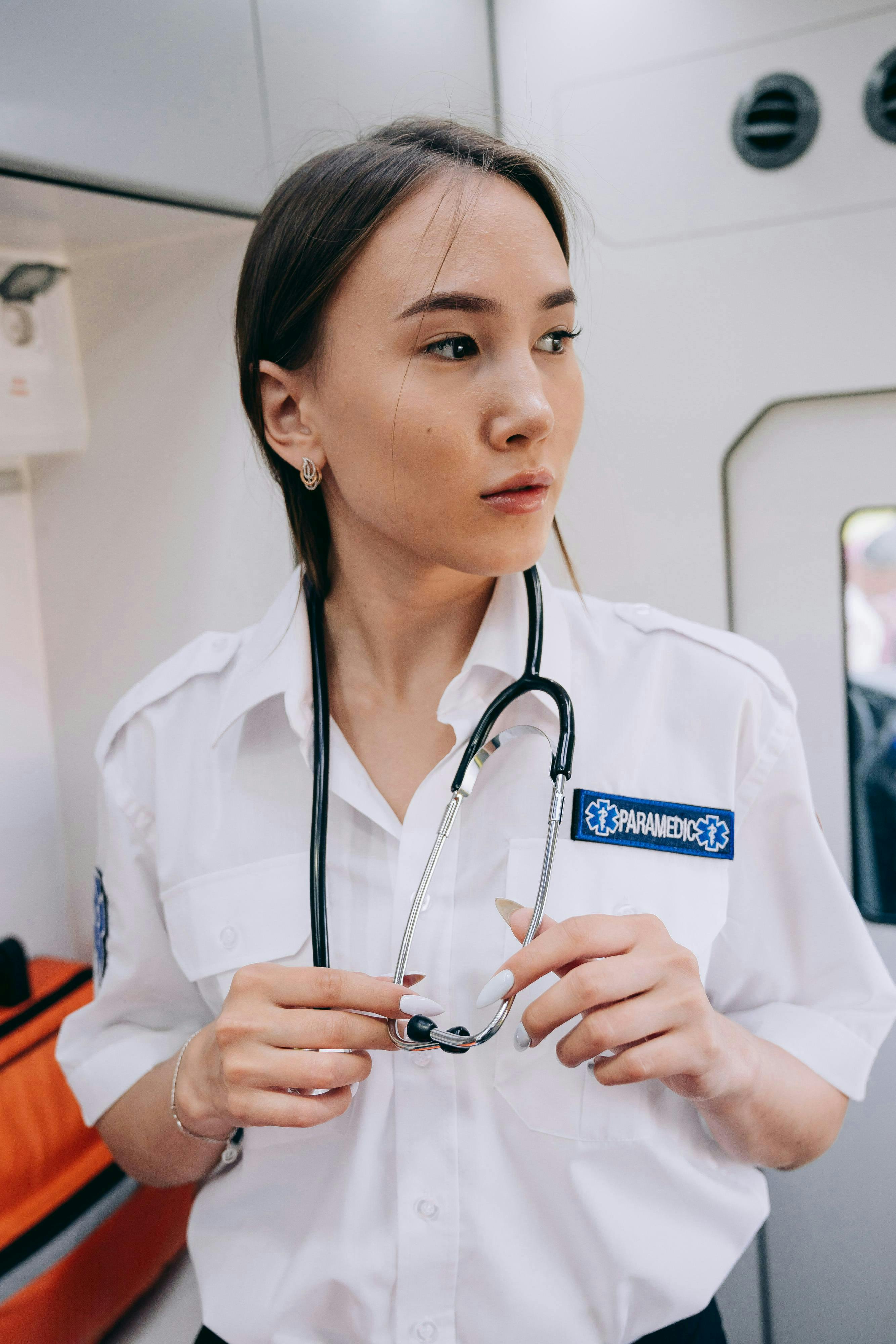 paramedic with stethoscope in ambulance