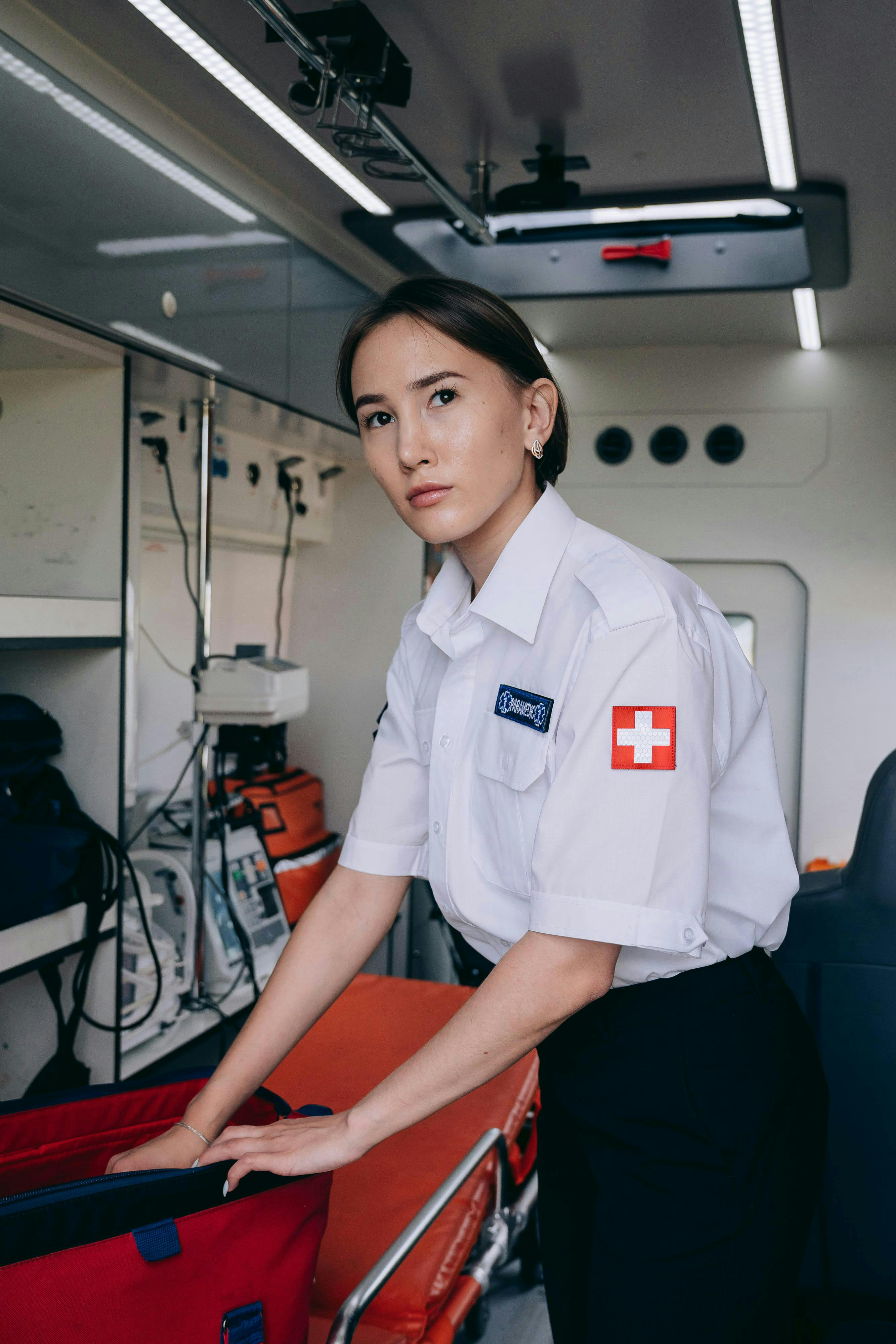 paramedic with medical bag at the back of an ambulance