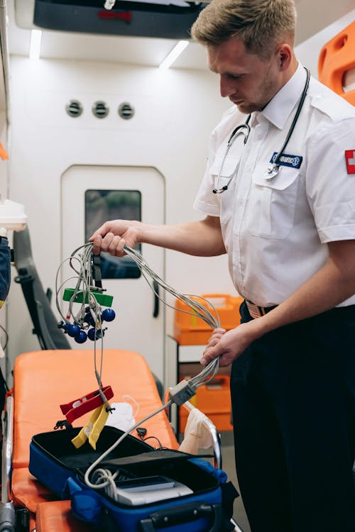 Paramedics Using a Defibrillator on a Patient · Free Stock Photo