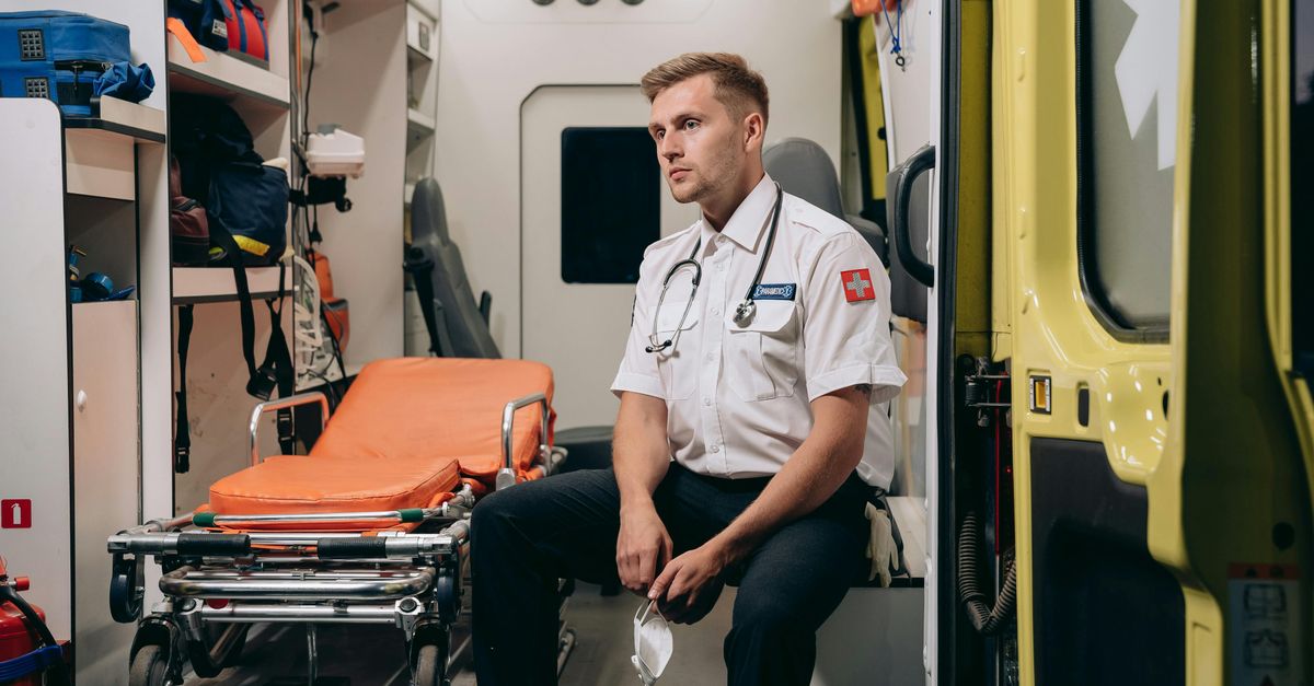 Paramedic Sitting in an Ambulance with a Face Mask in His Hands · Free ...