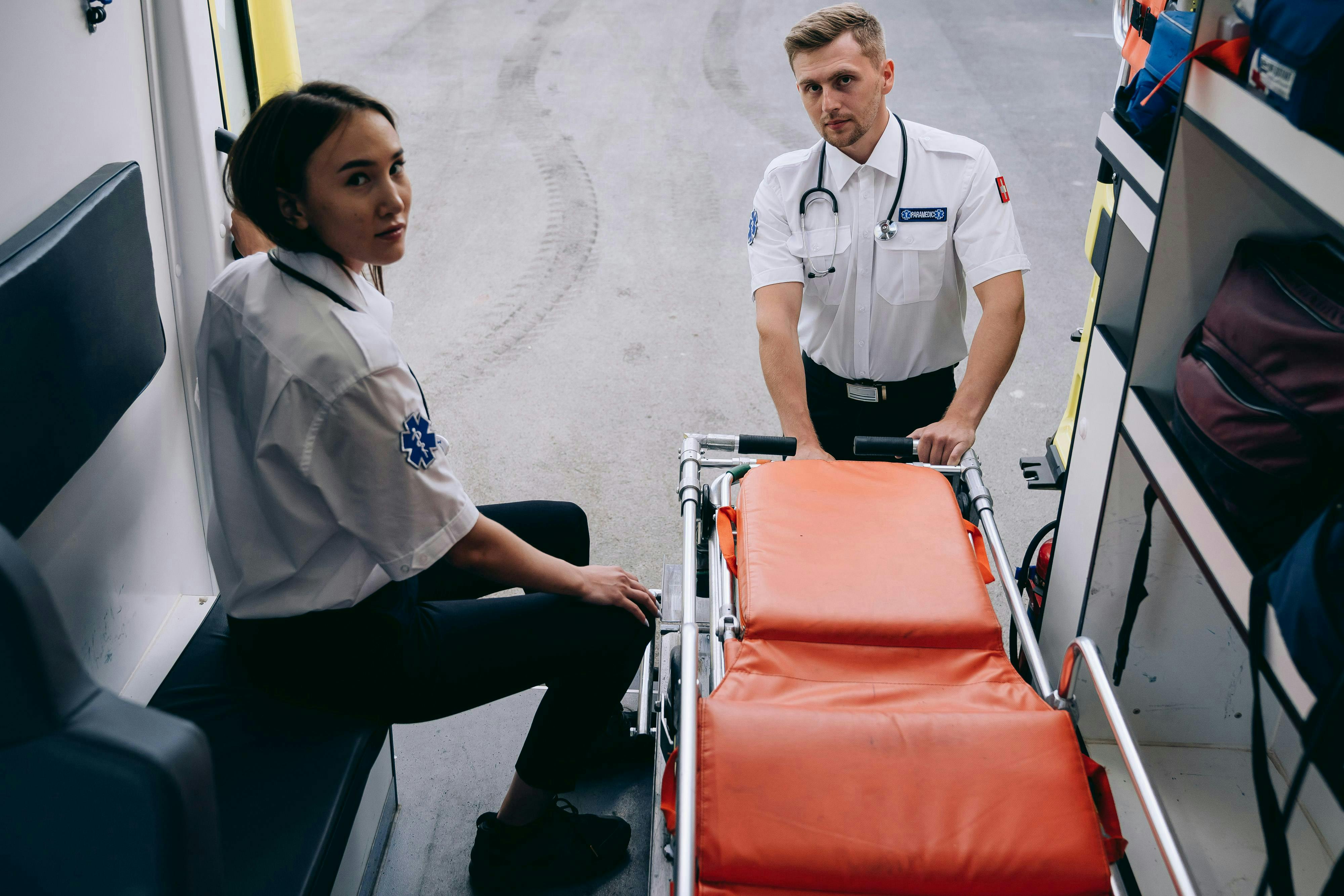 paramedics preparing a stretcher from an ambulance