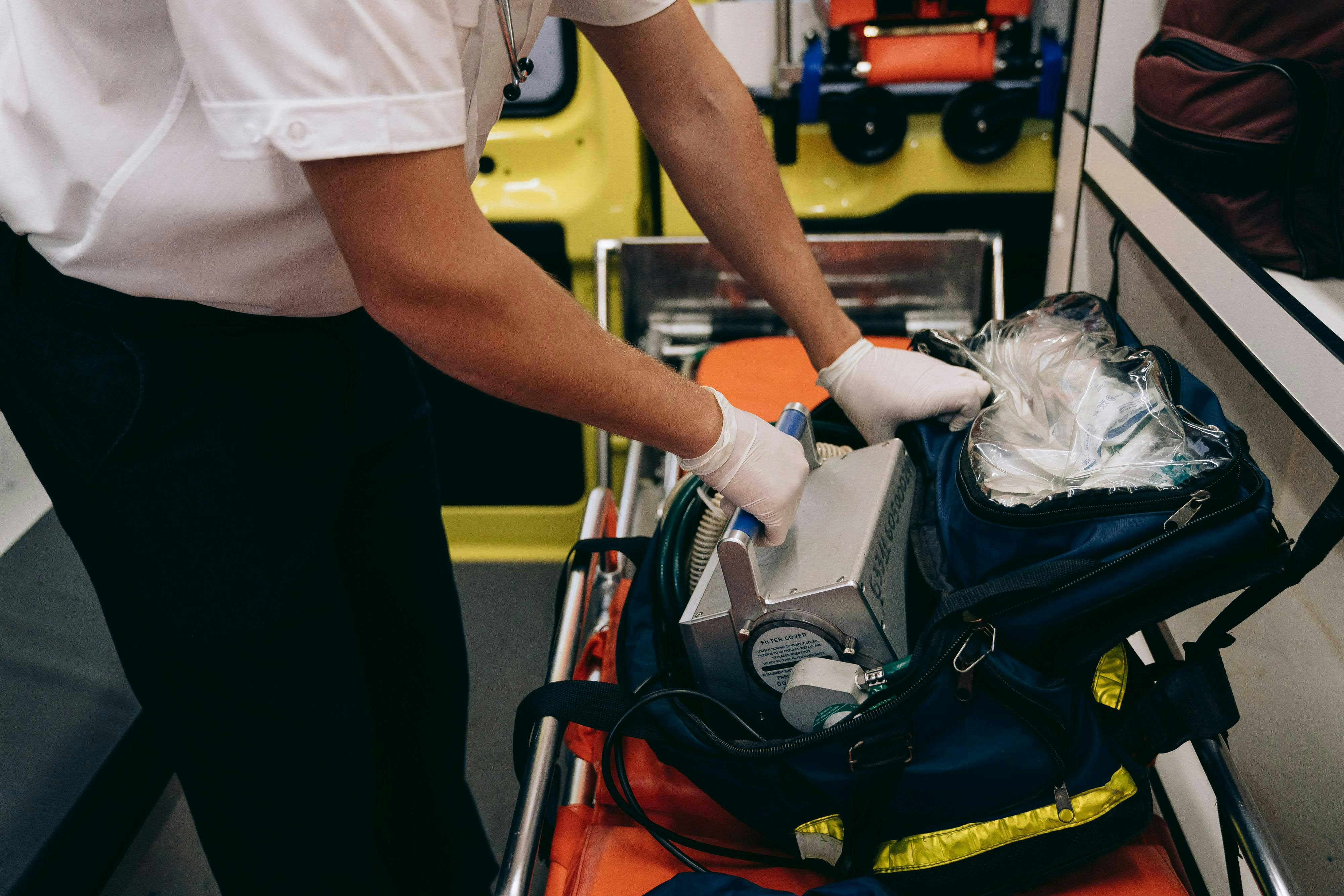 paramedic standing over bag