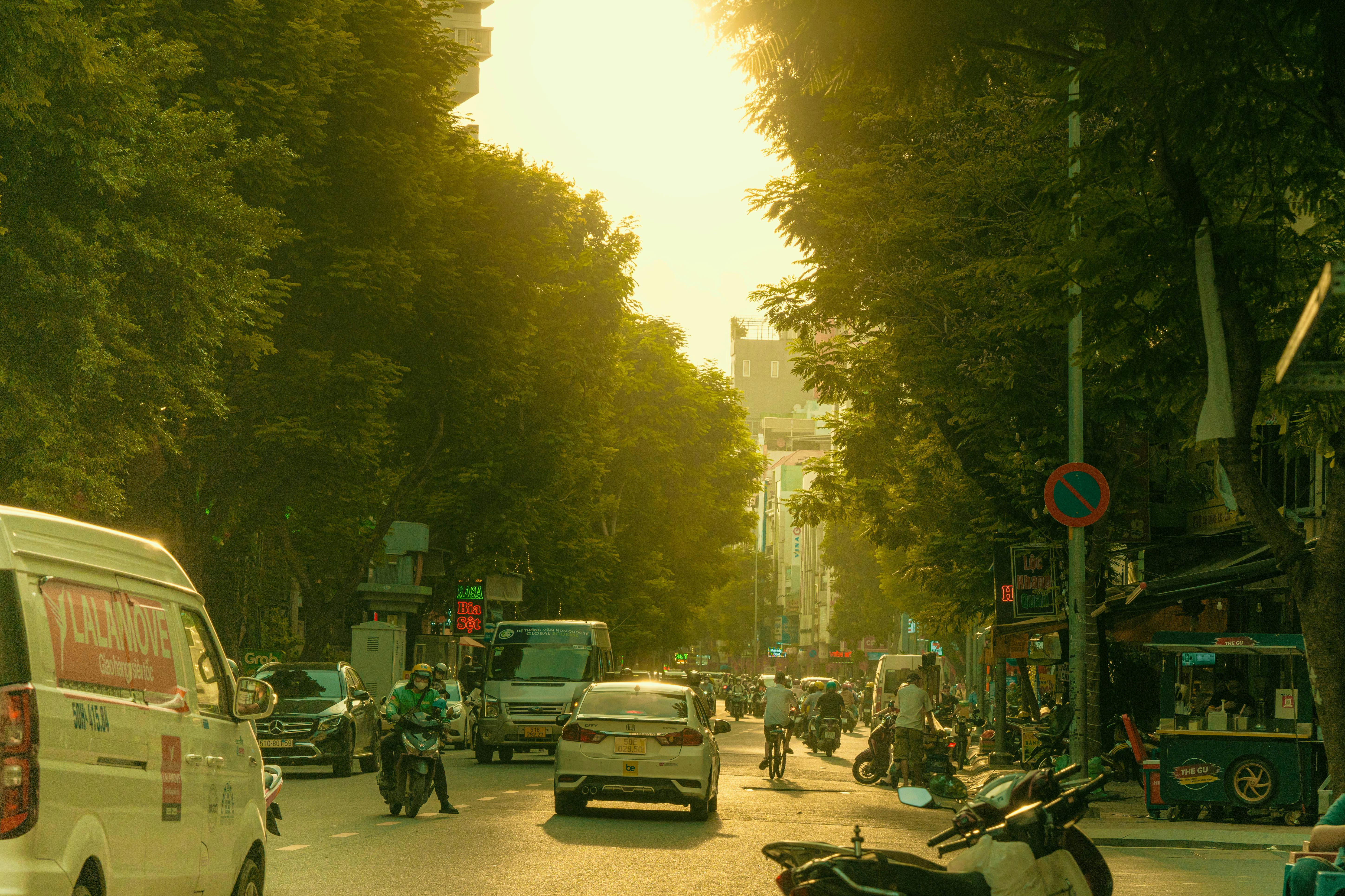 a street with cars and motorcycles on it