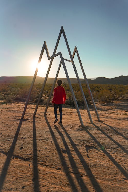 Free Boy Standing Under Triangular Frames Stock Photo