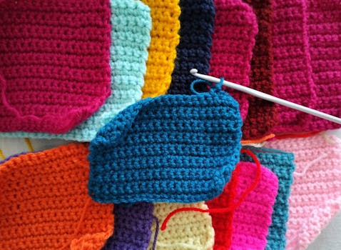 Bright and vibrant crochet squares in various colors with a crochet hook.