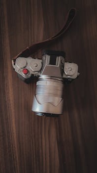 Elevate your photography collection with this stylish image of a vintage camera resting on wood, embodying retro elegance.