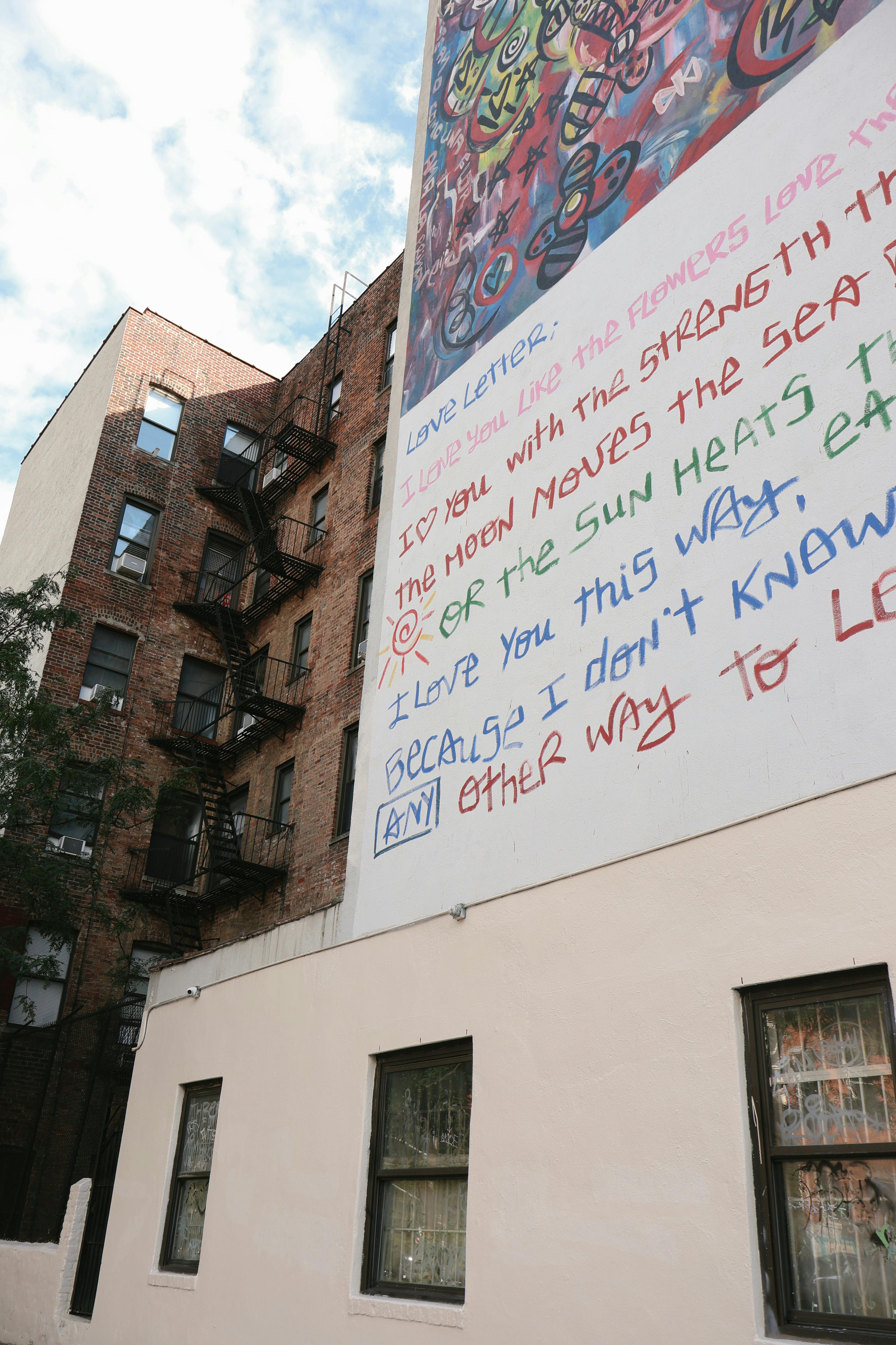 a large billboard with writing on it is on the side of a building