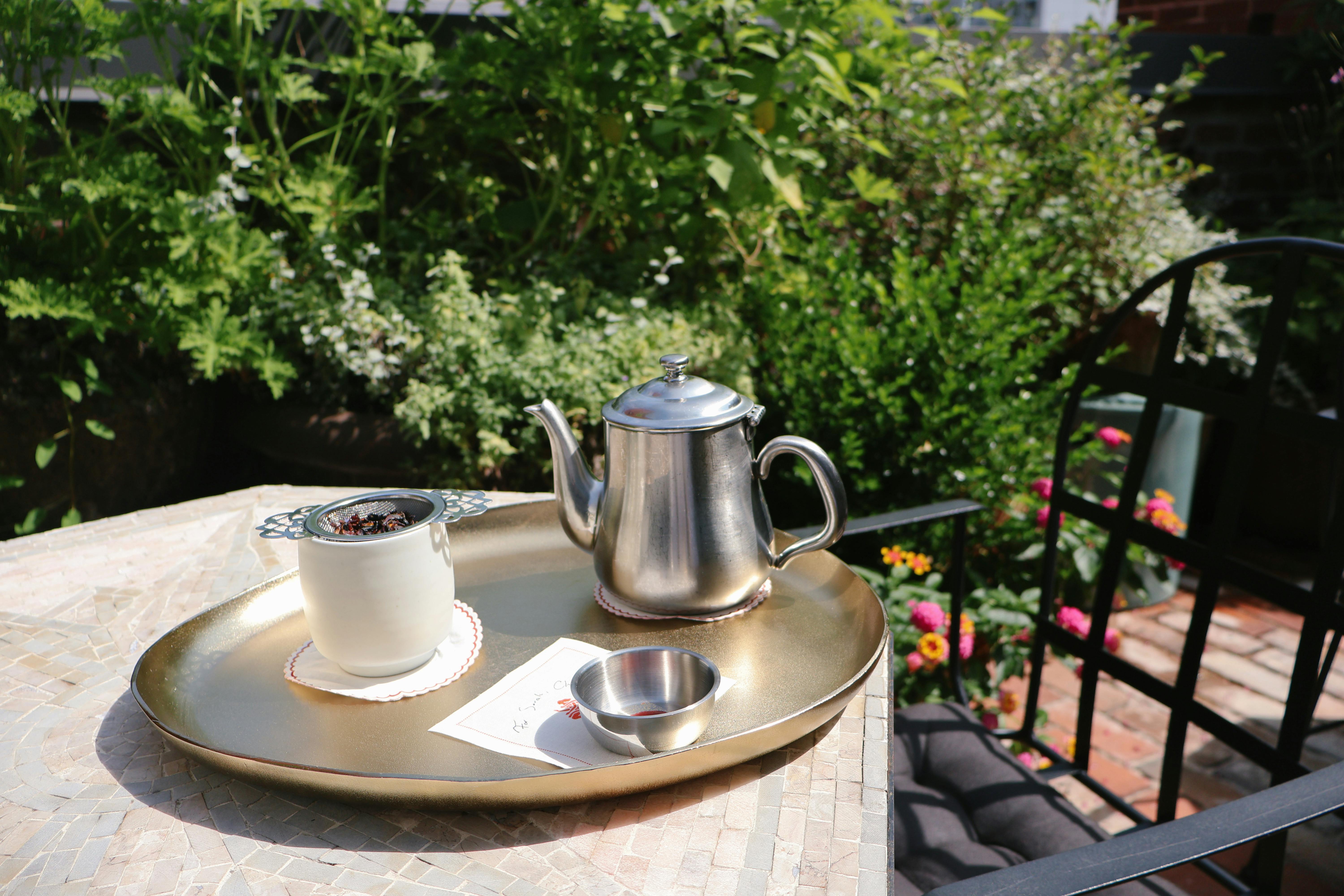 a tray with a cup and a teapot on it