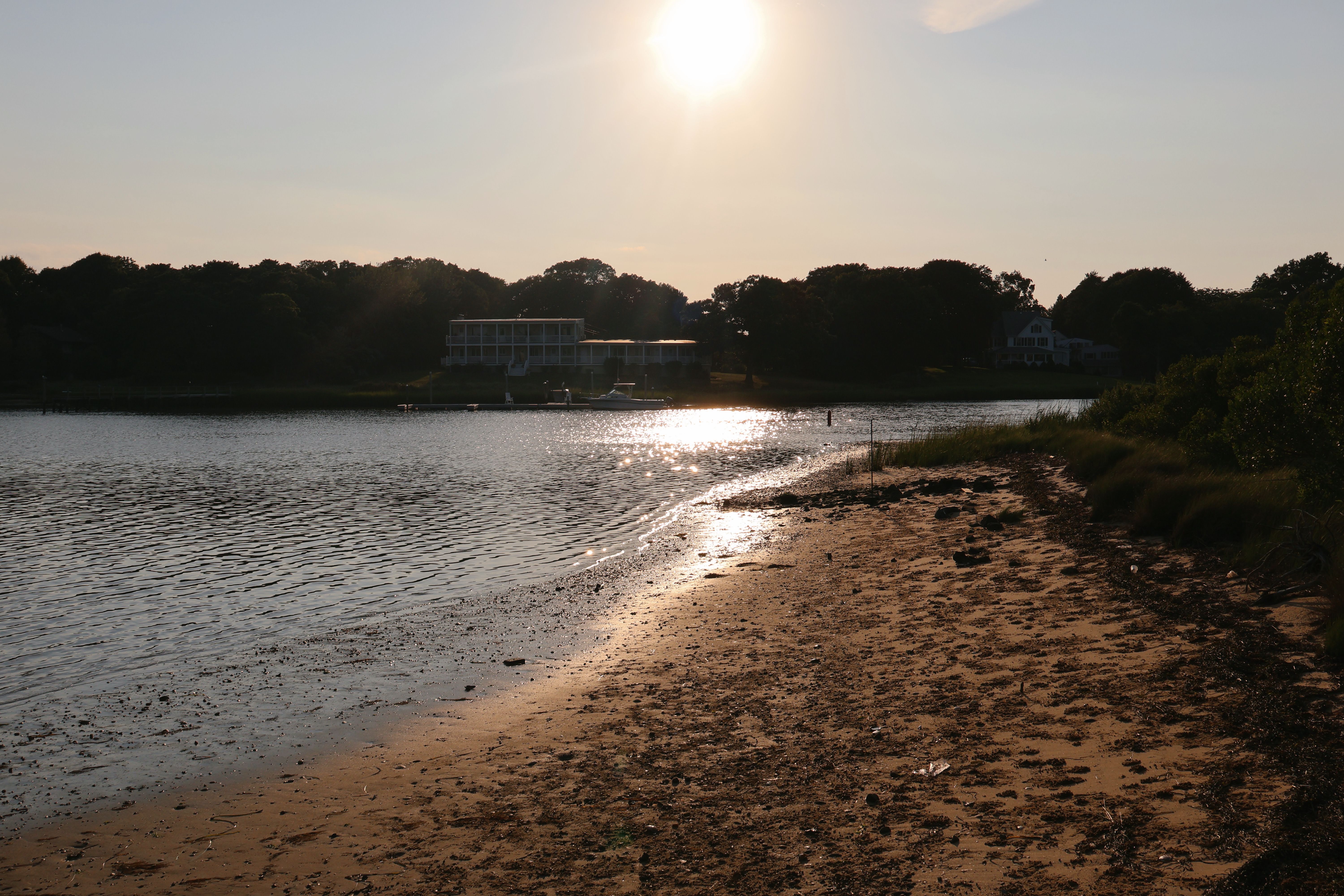 Captivating view of a sunset over a serene sandy beach in Hampton Bays.