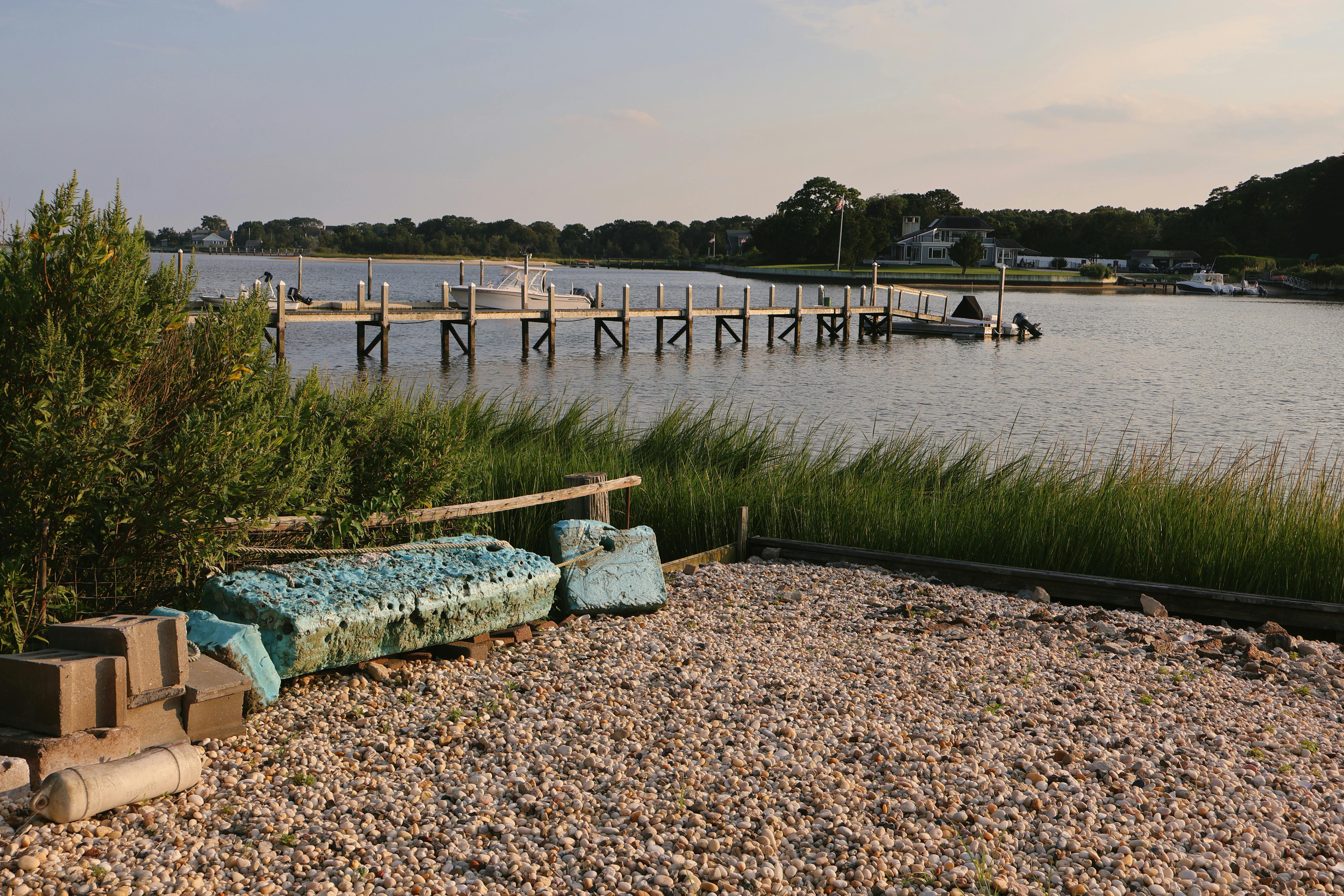 Tranquil summer scene capturing a dock and water view in Hampton Bays, New York.