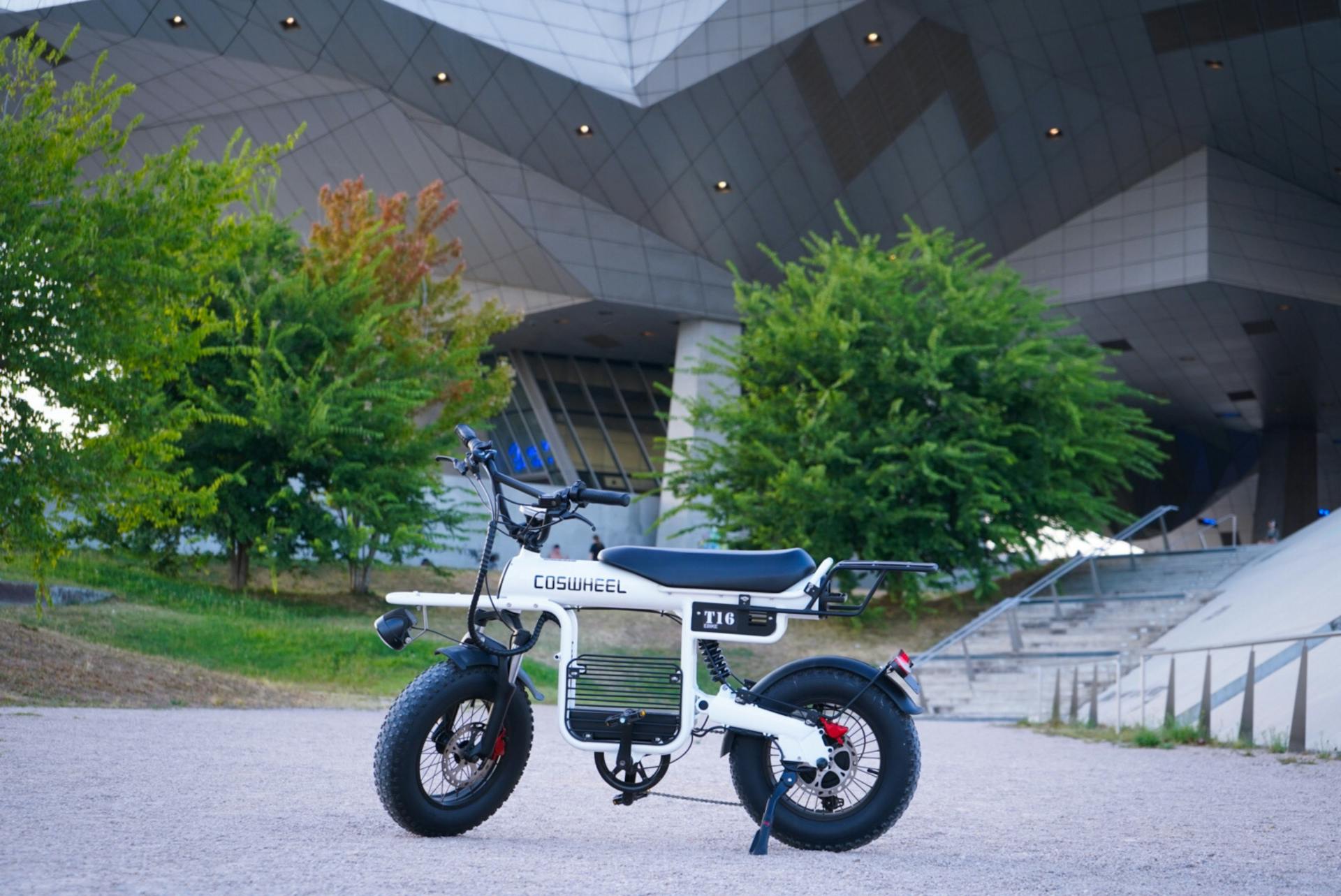 A white electric bike parked in front of a building