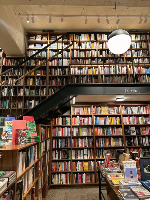 Classic wooden shelves with assorted books in store · Free Stock Photo