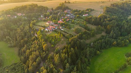 Free Charming aerial landscape of Čestín village during golden hour with lush greenery. Stock Photo
