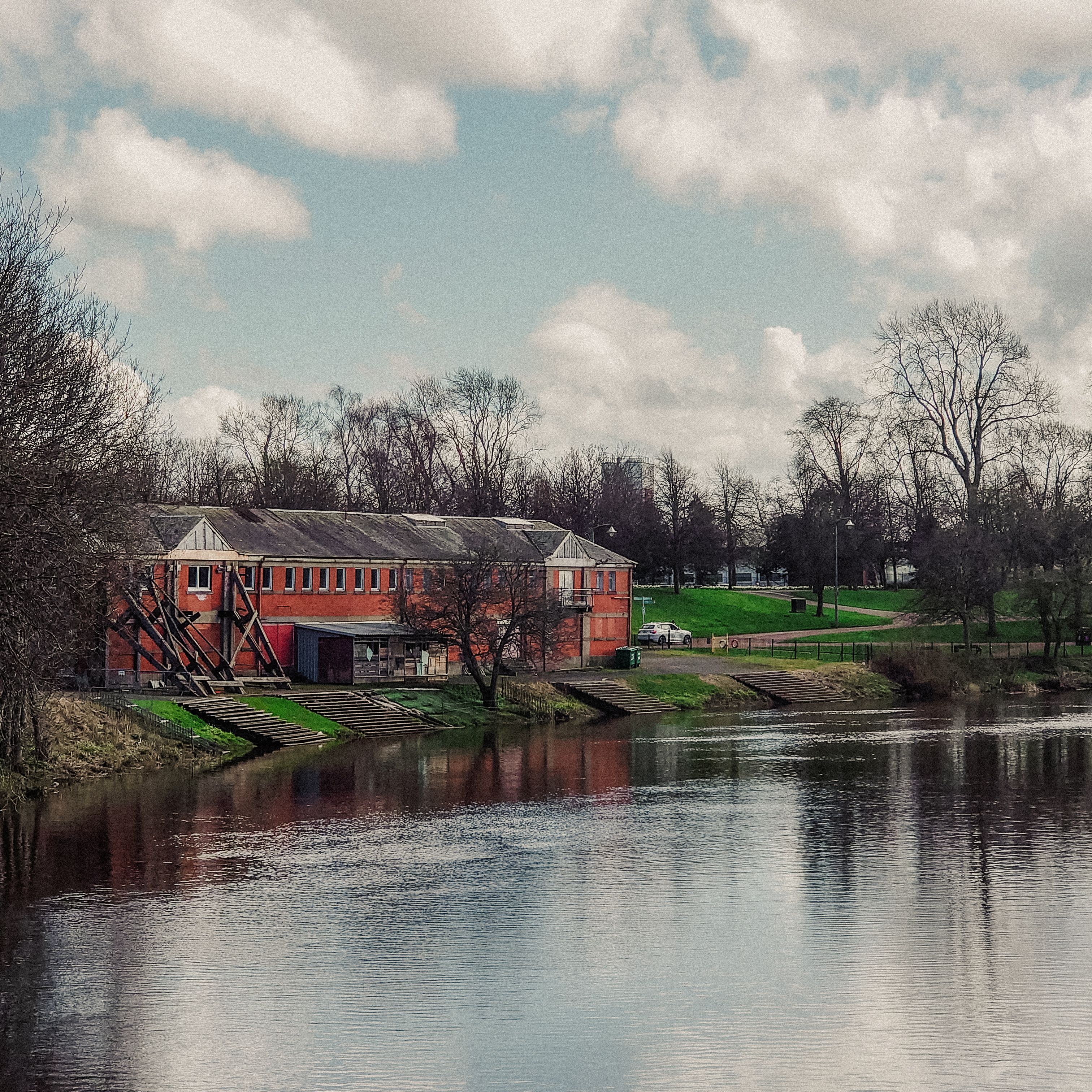 A large building sitting on a river bank · Free Stock Photo