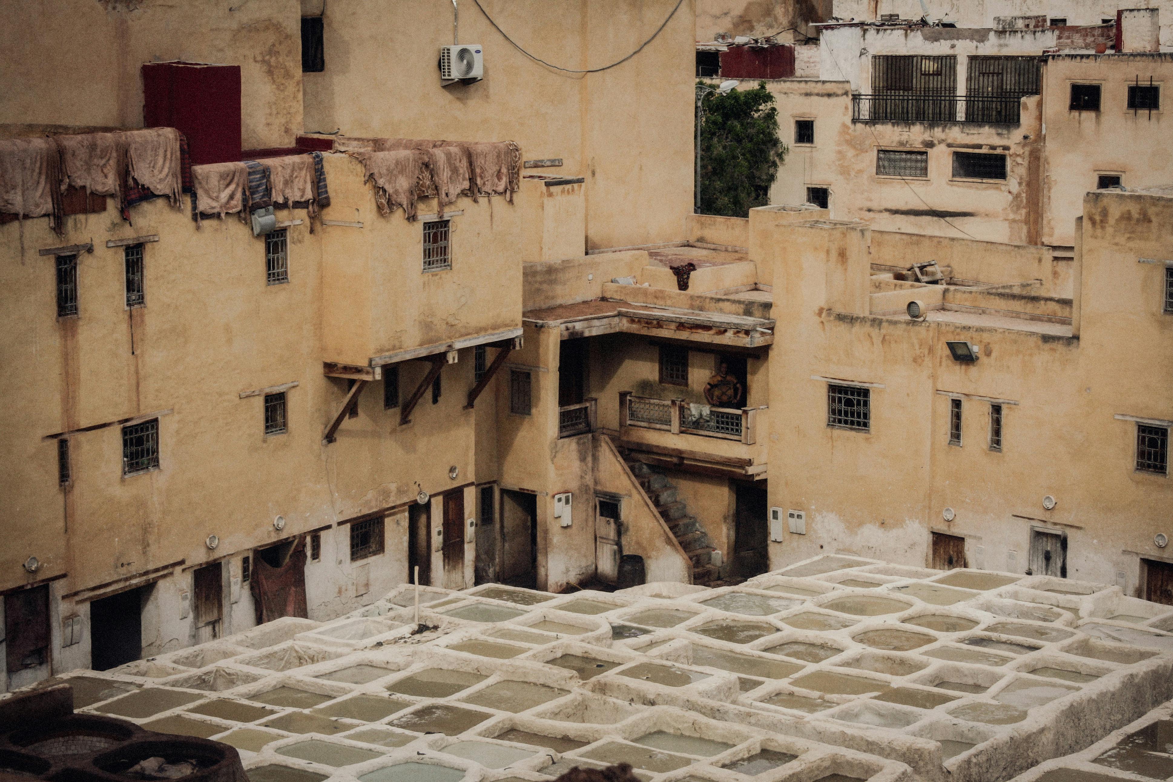 A courtyard with a lot of buildings and a fountain