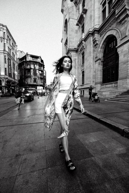 Stylish woman posing in a black and white street fashion shoot in Istanbul.