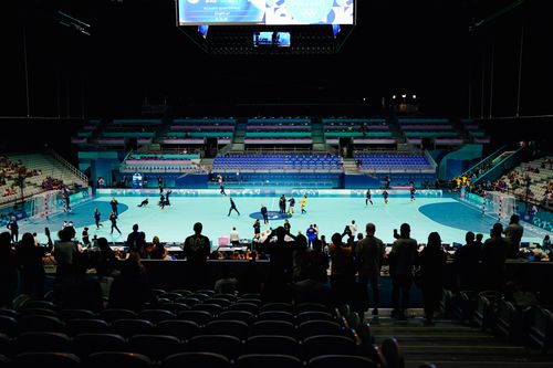 Free Spectators watching an indoor sports event in a stadium. Stock Photo