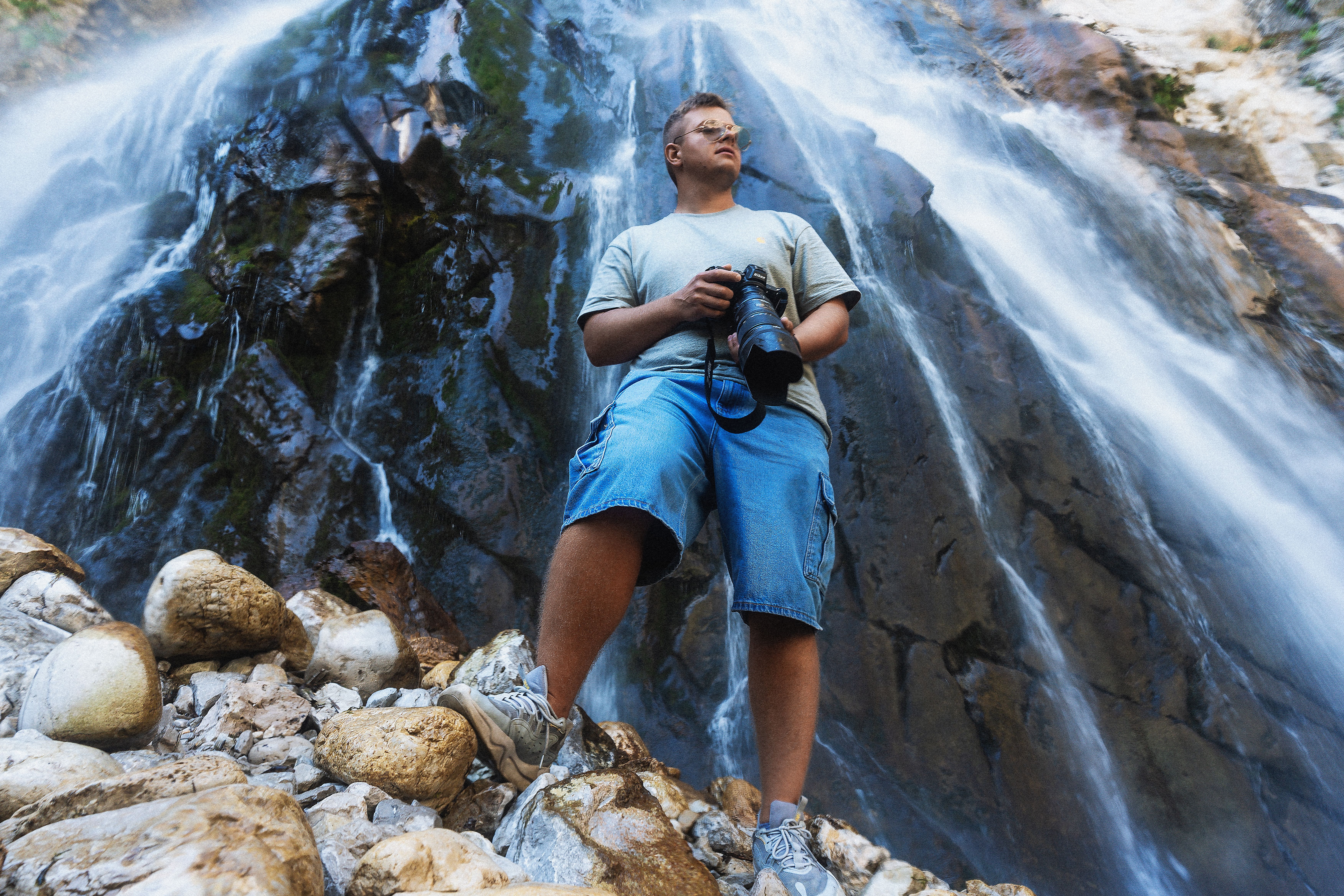 A man standing in front of a waterfall · Free Stock Photo