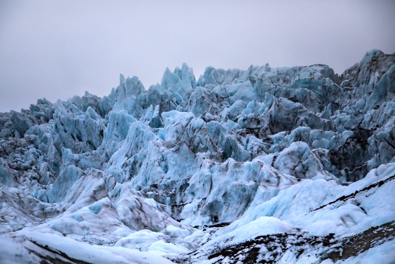 Massive glacier surrounded by rock — photo by Stephen Leonardi on Pexels