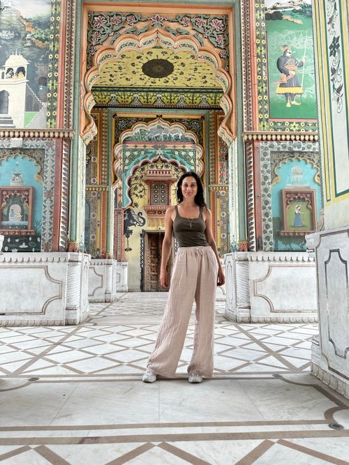 Free A woman stands in a beautifully decorated traditional Indian architectural setting. Stock Photo