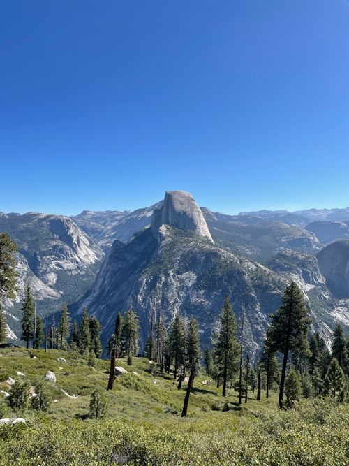 Free Stunning landscape view of Half Dome surrounded by lush forests in Yosemite National Park, California. Stock Photo