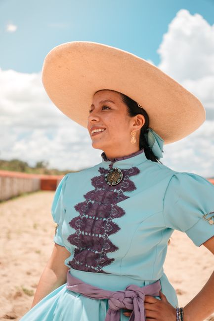 A vibrant portrait of a woman in traditional charro attire showcasing Mexican culture.