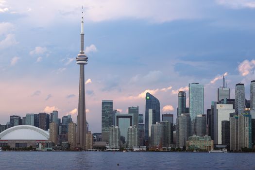 Scenic view of Toronto skyline with CN Tower at sunset, over Lake Ontario.