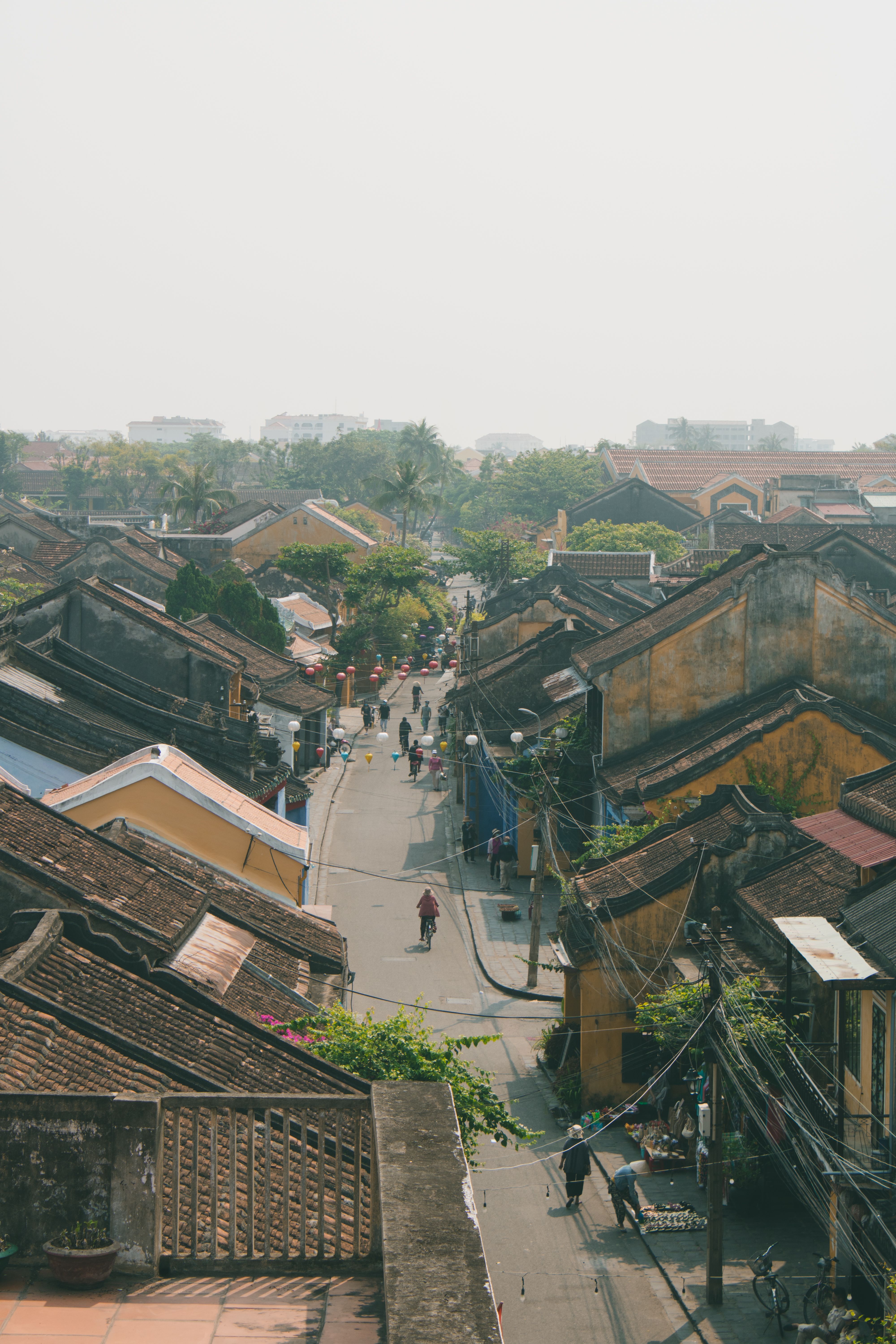 Aerial view of a bustling street in Hội An's historic district, showcasing traditional architecture.