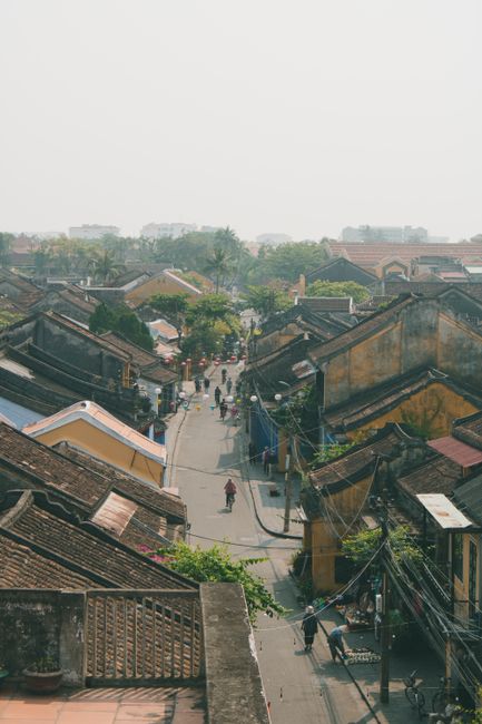 Aerial view of a bustling street in Hội An's historic district, showcasing traditional architecture.