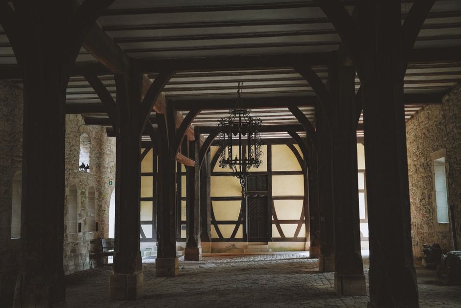 modern interior featuring an exposed stone wall and wood ceiling beams - stone and wood building modern interior featuring an exposed stone wall and wood ceiling beams - stone and wood building
