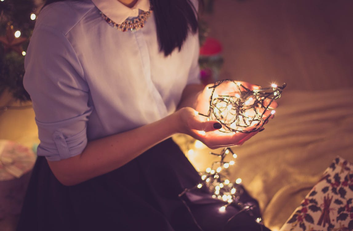 Woman Holding String Lights