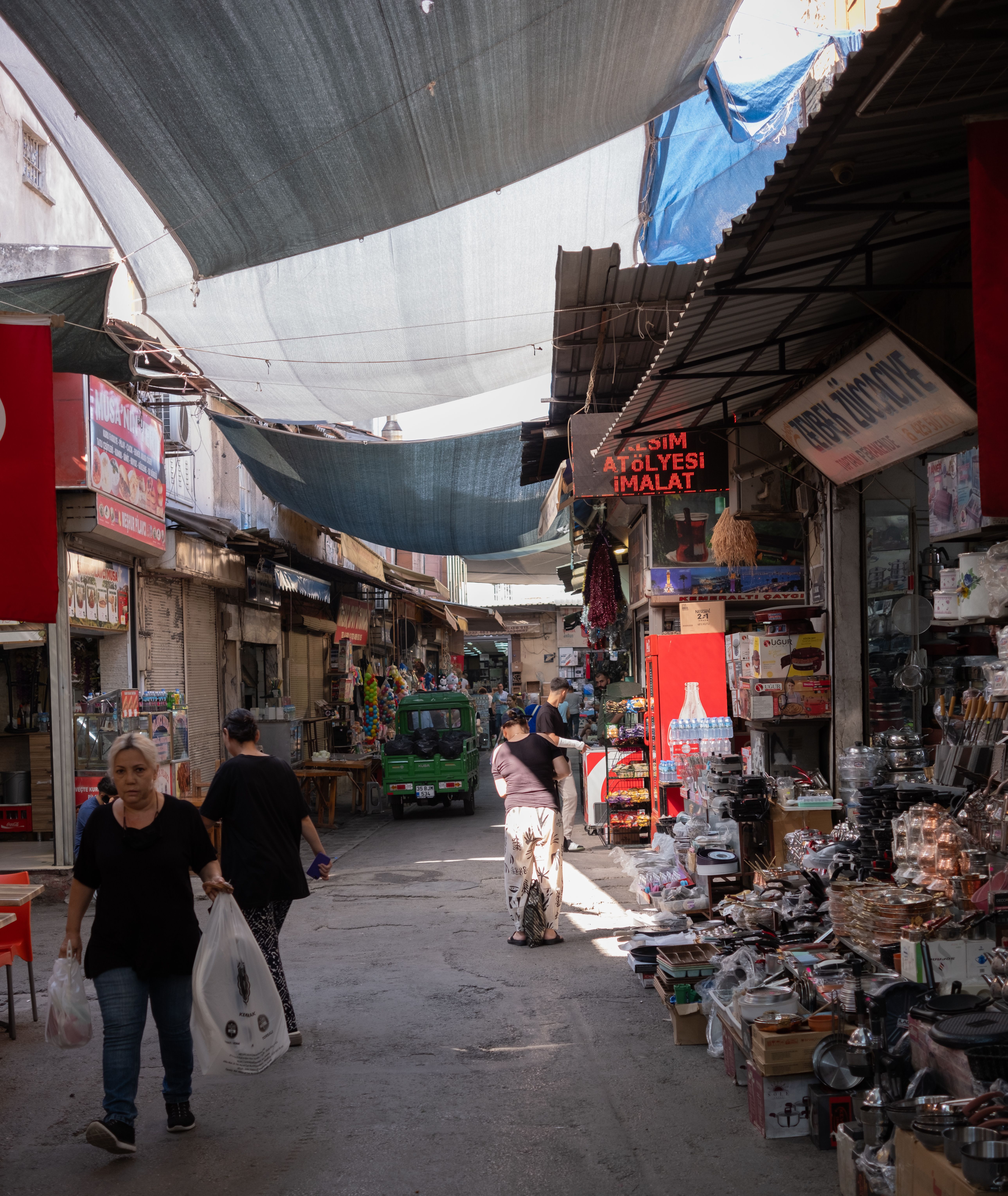 A street with people walking through it and a market · Free Stock Photo