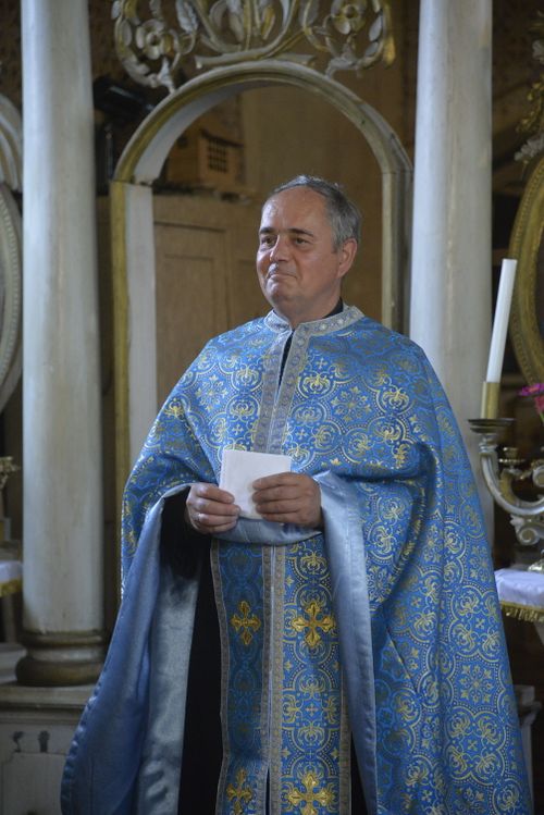 Free A Greek Orthodox priest in ornate blue robes inside a historic church. Stock Photo